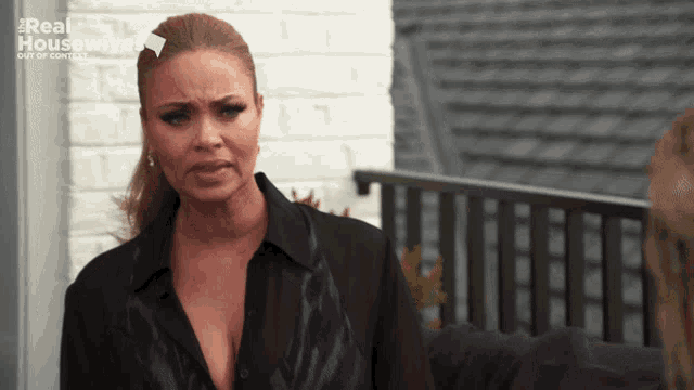 a woman in a black shirt with the words real housewives on the bottom