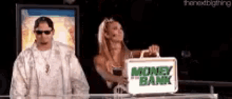 a man and a woman are standing next to a briefcase that says money bank