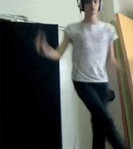 a man in a white shirt and headphones is dancing
