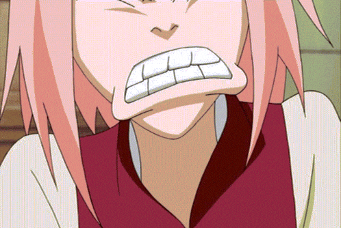 a close up of a girl with pink hair making a face