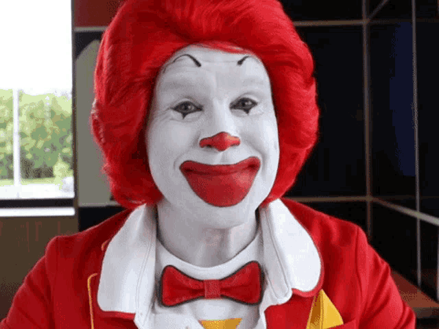 a man dressed as mcdonald 's clown with red hair