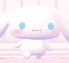 a white stuffed animal with blue eyes is sitting on a pink surface .