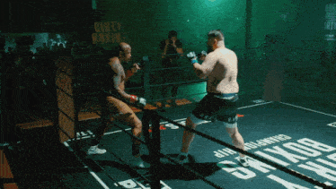 two men are fighting in a boxing ring with dirty boxing written on the mat