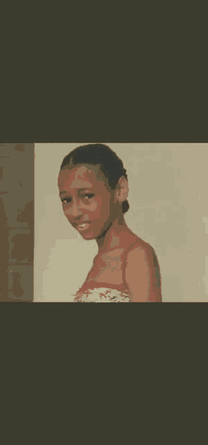 a girl in a red tank top is standing in front of a white wall .