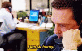 a man talking on a phone with the words i am so horny