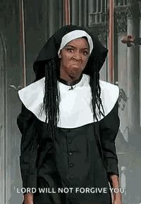 a woman is dressed as a nun and making a funny face .