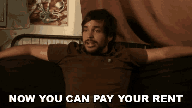 a man laying on a bed with his arms outstretched and the words now you can pay your rent