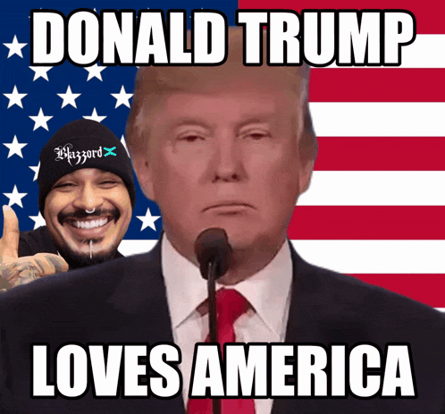donald trump giving a speech in front of an american flag with a man in a beanie behind him