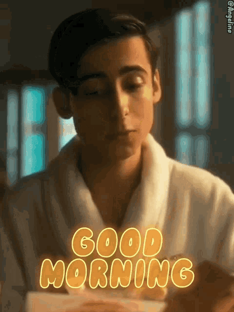 a man in a robe says good morning while holding a box