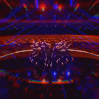 a group of people are dancing on a stage