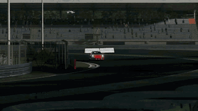 a red sports car is driving down a road
