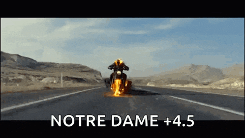 a person is riding a motorcycle on a highway with the words notre dame +4.5 above them