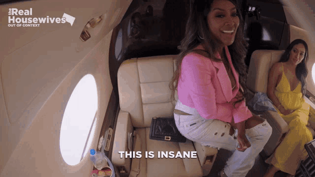 two women are sitting on a plane with the words this is insane below them