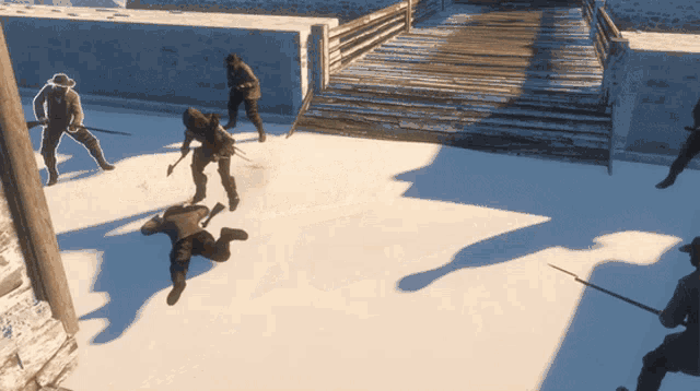 a group of men are playing a video game and one is laying on the ground