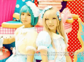 a girl with blue hair and a girl with blonde hair