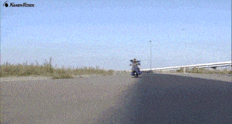 a person is riding a motorcycle on a road with kamen rider written on the bottom