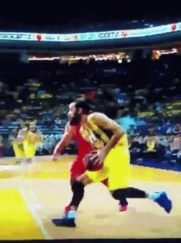 a basketball game is being played in a stadium with a sign that says ' scott ' on it