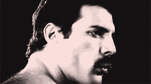 a black and white photo of a man 's face with a mustache