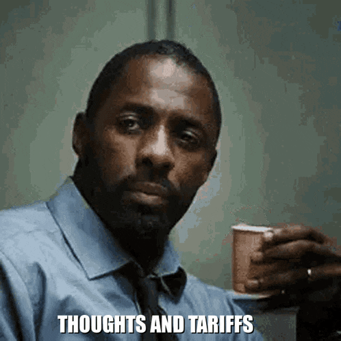 a man in a blue shirt and tie is holding a cup of coffee .