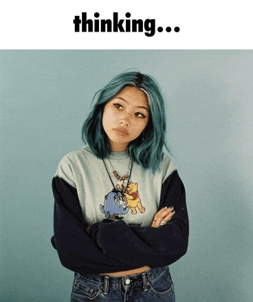 a girl with blue hair is wearing a winnie the pooh t-shirt