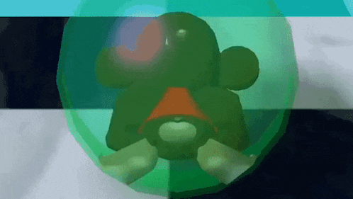 a green cartoon character with a red hat is in a green bubble .