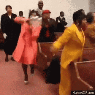 a group of people are dancing in a church while sitting in chairs .