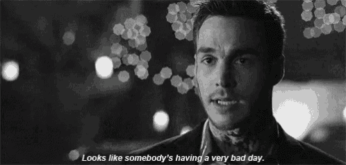 a black and white photo of a man with a quote that says looks like somebody 's having a very bad day