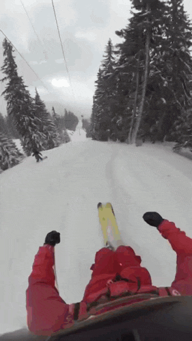 a person in a red jacket is skiing down a snow covered hill
