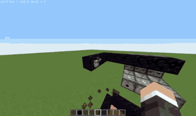 a screenshot of a minecraft game shows a person holding a block in a corner