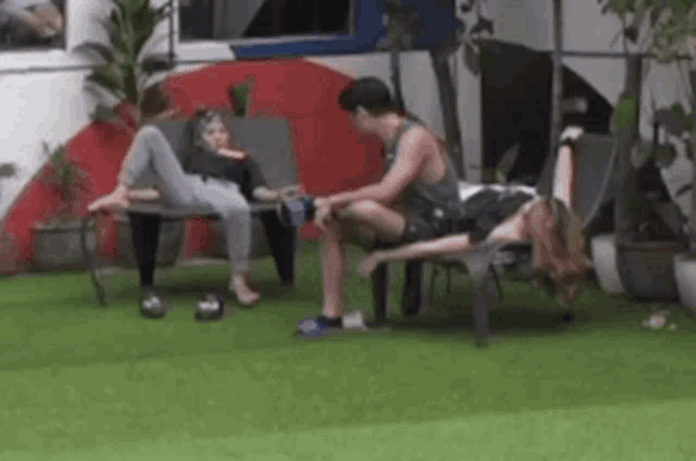 a group of people are sitting on chairs in a backyard .