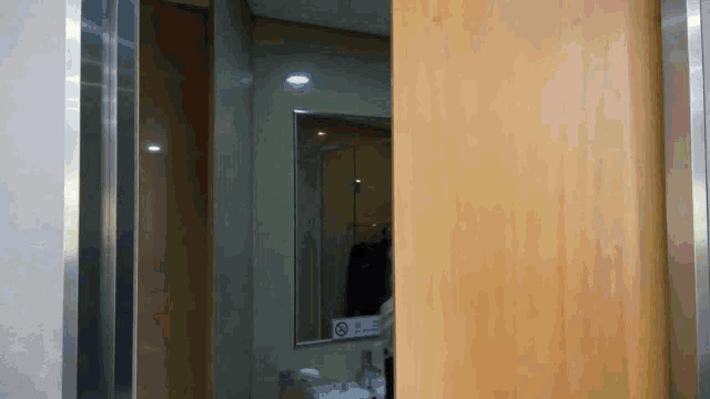 a bathroom with a sign that says no smoking on it