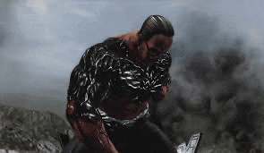 a man is being attacked by a monster in a video game while holding a gun .