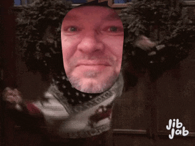 a man 's face is cut out of a sweater with jib jab written on it