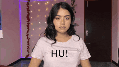 a woman wearing a white t-shirt that says hu