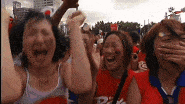 a group of people are standing in a crowd and one of them is wearing a shirt that says pa .