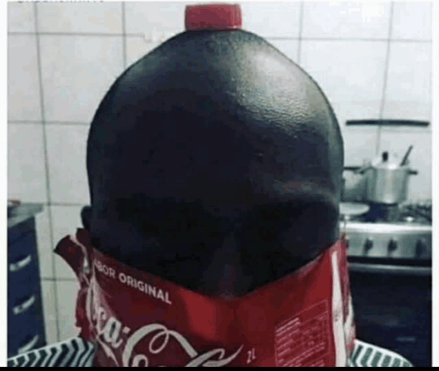 a bottle of coca cola is sitting on top of a bag