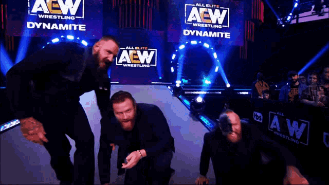 three aew wrestlers are posing for a picture