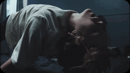 a person is laying on their back with their head on the floor