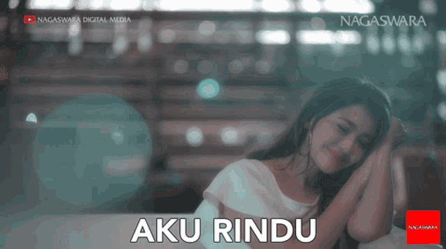 a video of a woman with the words aku rindu written below her