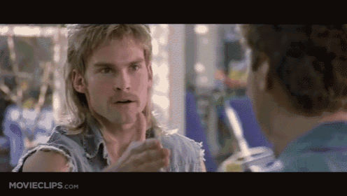 a man with a mullet is talking to another man with movieclips.com on the bottom of the screen