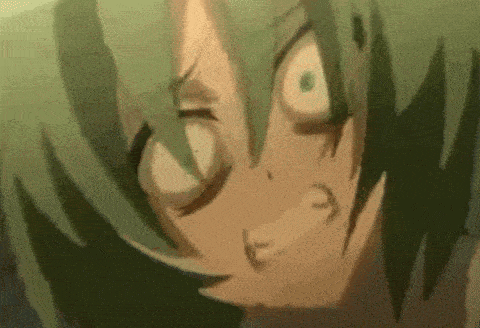 a close up of a person 's face with green hair making a face .