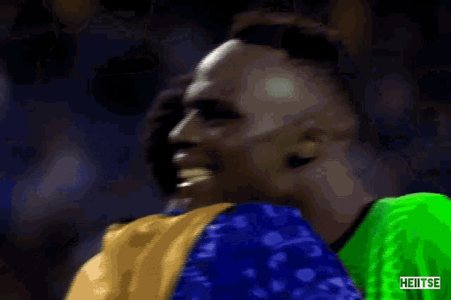 a soccer player in a green jersey with the word heitse on the bottom