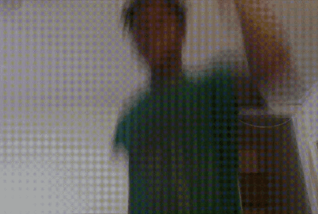 a blurry picture of a person 's face with a polka dot background
