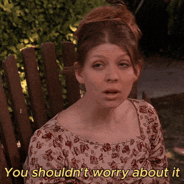 a woman sitting in a wooden chair with the words you shouldn 't worry about it written below her