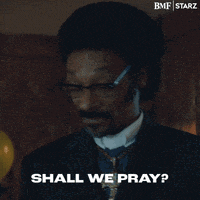 a man with glasses and a cross necklace says " shall we pray "