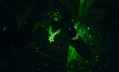a man in a black shirt with a pentagram necklace