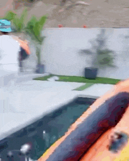 a person is riding a raft in a pool .