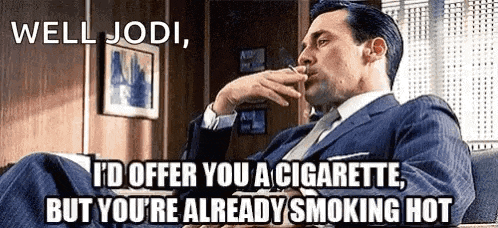 a man in a suit and tie is smoking a cigarette in a chair .