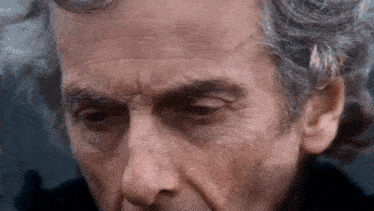 a close up of a man 's face with wrinkles on it
