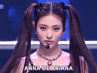a girl with pigtails and a necklace that says anna de ariana on it